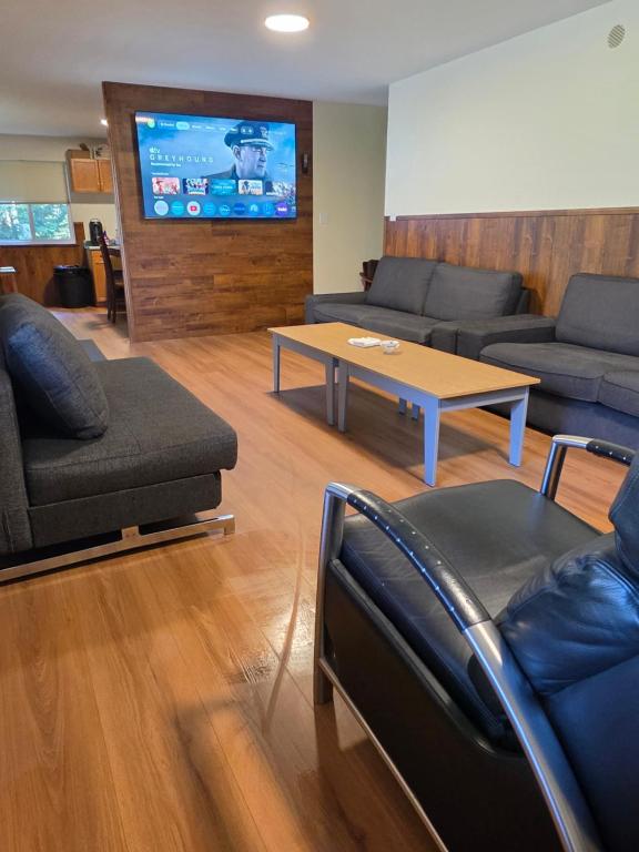a living room with couches and a table and a tv at Hope Sunshine Valley Scenic Mountain View House 3BR 3Bath in Hope