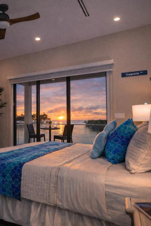 a bedroom with a bed with a view of the ocean at Oceanfront 5BR+ Bonus Room•75’ Dock •Pool-Spa •Kids area •Walk to Sombrero Beach in Marathon