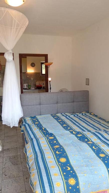 a bedroom with a bed with a wedding dress on it at Kuća u zelenilu in Poljane