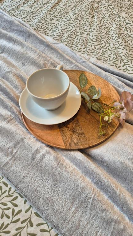 a plate with a cup and a bowl on a table at Kościuszki Centrum Apartment in Łódź