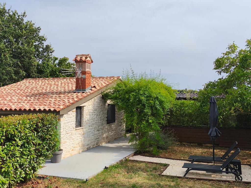 a bench in front of a brick house at Casa Colone in Bale