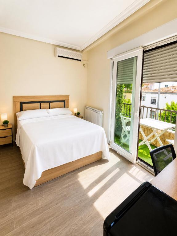 a bedroom with a bed and a large window at ELAN LEVEL Parla in Parla