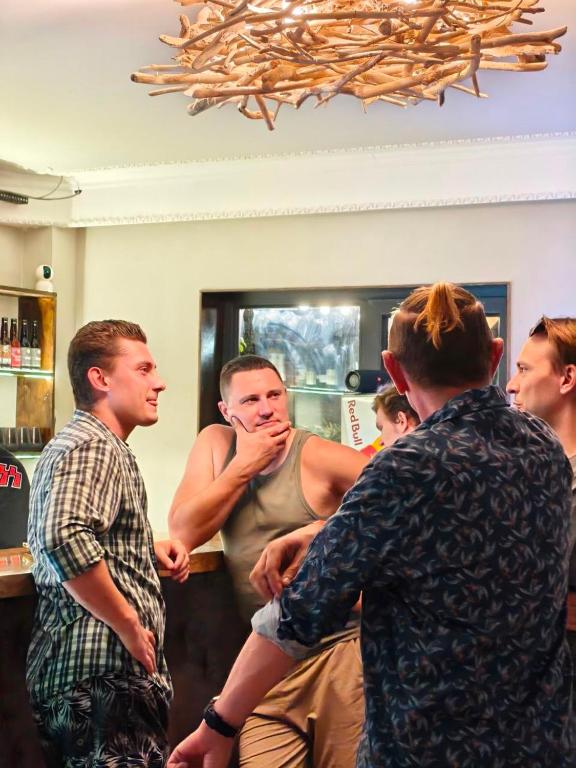 a group of men standing around in a room at Camp & Hostel Maltakva in Poti