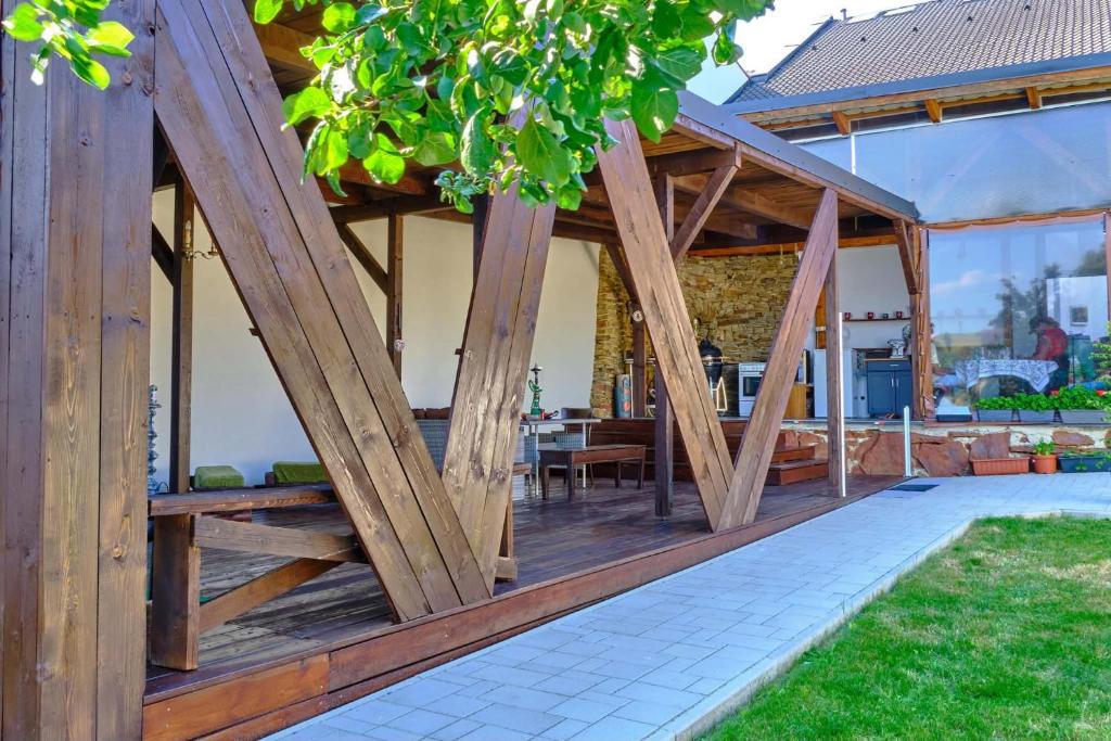 a wooden pavilion with a table and chairs in a yard at Villa Axa in Vrbov