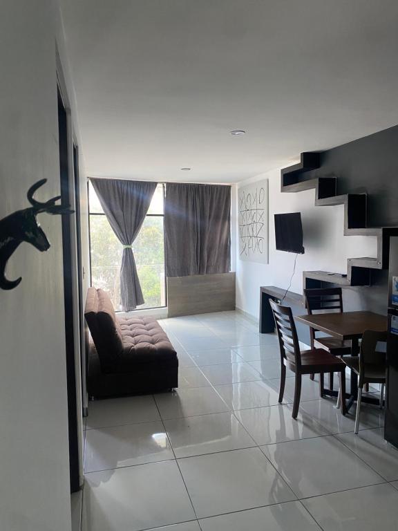 a living room with a couch and a table and chairs at Hermoso Departamento Ejecutivo 2 in Guadalupe