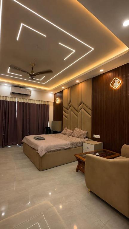 a bedroom with a bed and a couch in it at V studio in Ghaziabad
