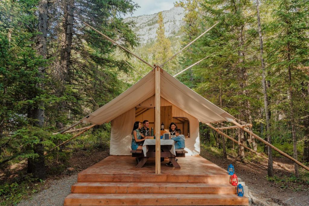 three people sitting at a table in a tent at Sundance By Basecamp in Kananaskis Village