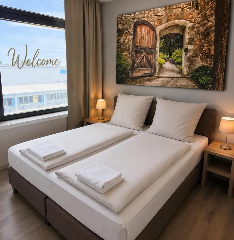a bedroom with a bed with a door and a window at Aparthotel Emilia 24h Check-in, Free Parking and WiFi in Bargteheide