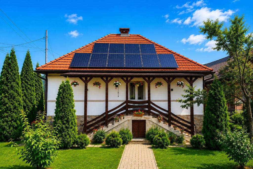 a house with solar panels on the roof at Casa Zsolt Vendégház in Sovata