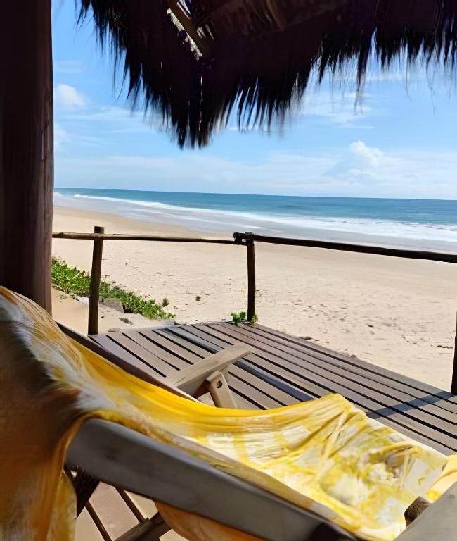 a hammock on a beach with a view of the ocean at Licuri Praia de Algodões paz amor na beira do mar in Marau