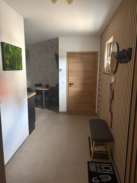 a hallway with a door and a table and a chair at Ferienwohnung Am Schlagbaum in Kaltennordheim