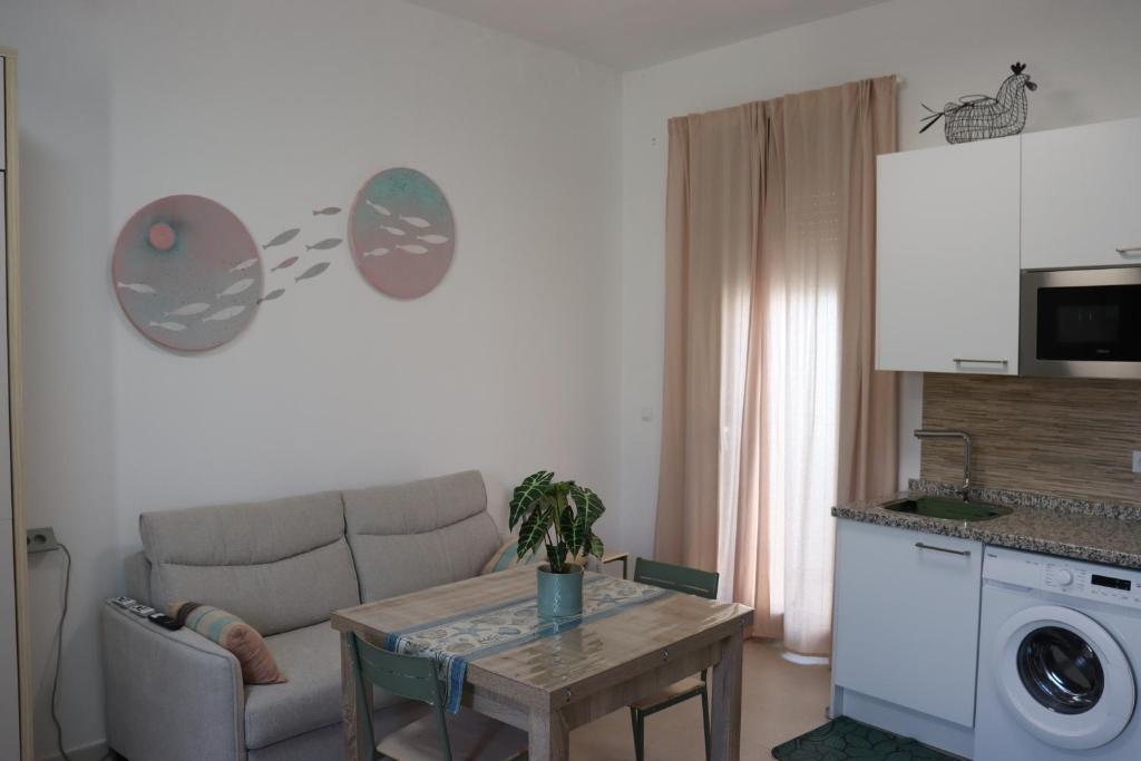 a living room with a couch and a table at Estudio Puerto Isla in Isla Cristina
