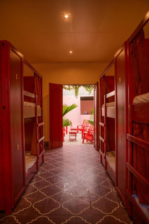 a hallway with bunk beds and a room with a patio at Casa Remolacha in Flores