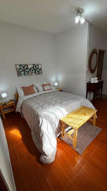 a bedroom with a large bed and a table at El rincón in Merlo