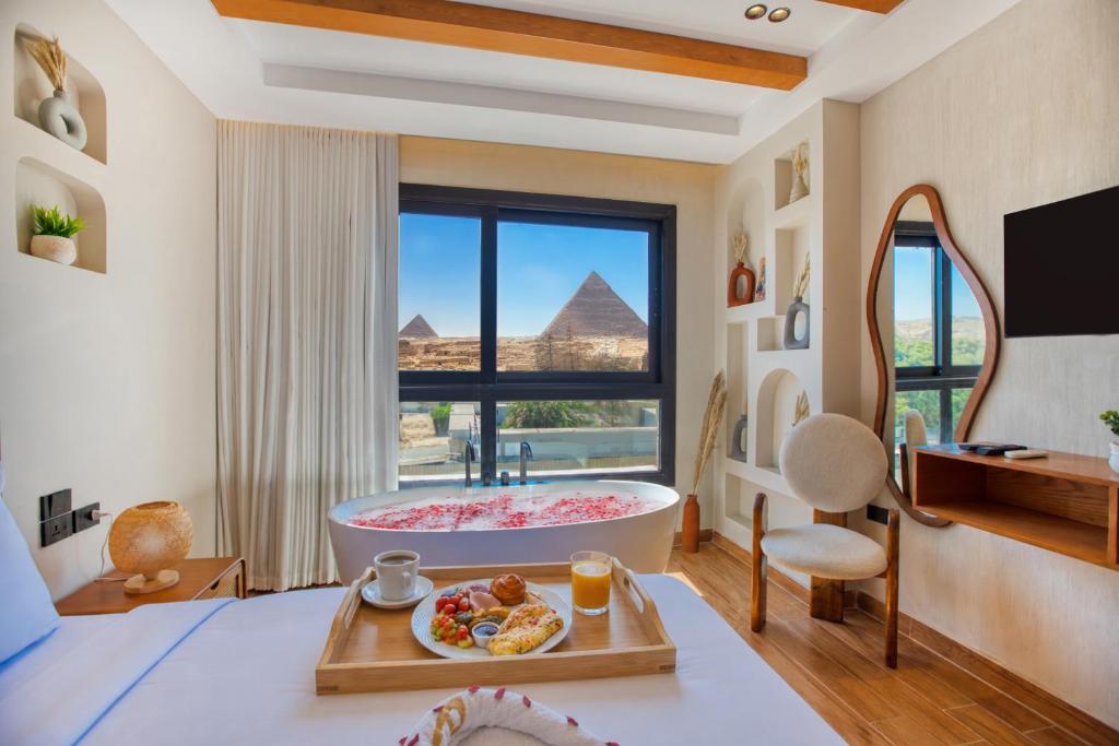 a bathroom with a tub and a view of the pyramids at PANORAMA view pyramids in Cairo