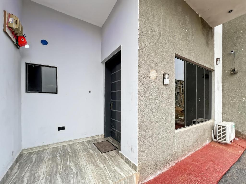 a room with a door and a television on a wall at Domina Serviced Apartment in Kubwa