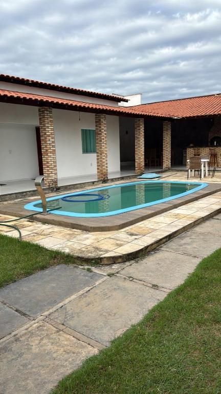 a swimming pool in front of a house at pousada ilha do amor in Barreirinhas