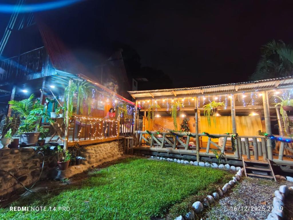 a house with christmas lights in the yard at Montañita Lodge in La Merced