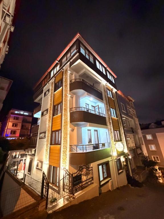 a tall building with lights on it at night at Çakır Residence in Trabzon