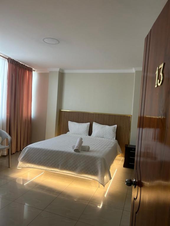 a bedroom with a large bed with lights on it at Hotel Danmar in Ventanas