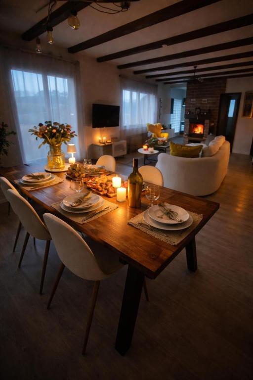 a wooden table in a living room with a couch at Havre de paix avec jacuzzi in Grône