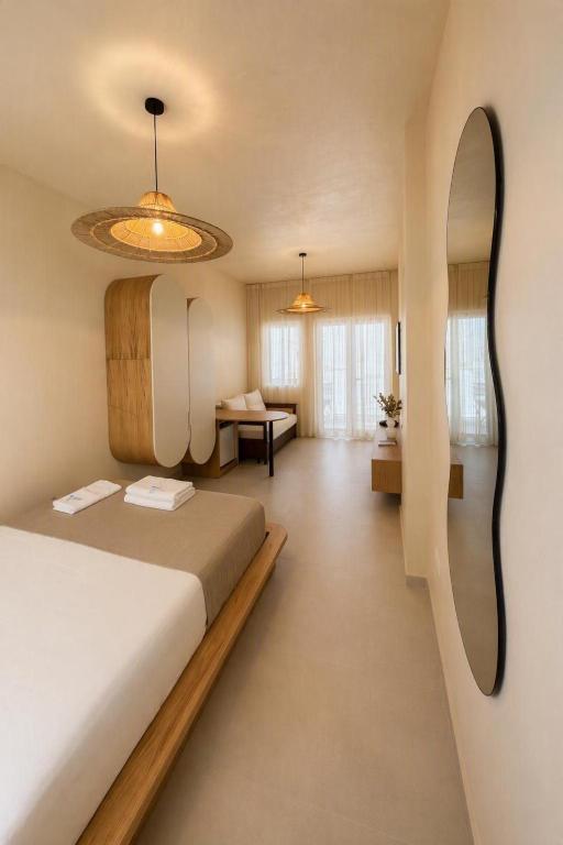 a hotel room with a bed and a desk at Delor Studio Drymades,Santorini in Dhërmi