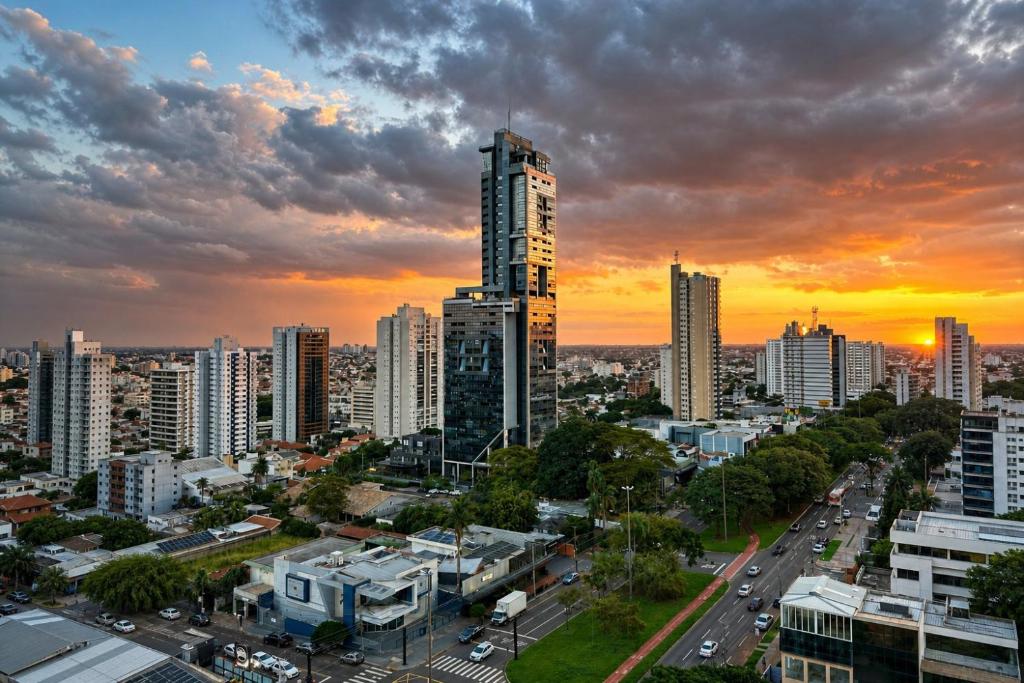 a cityscape of a city at sunset at Vertigo Premium Studios in Campo Grande