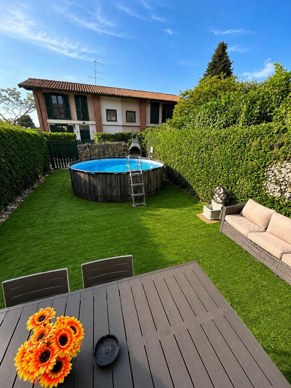 a wooden table with flowers on top of a yard at Villetta faustina in Albairate