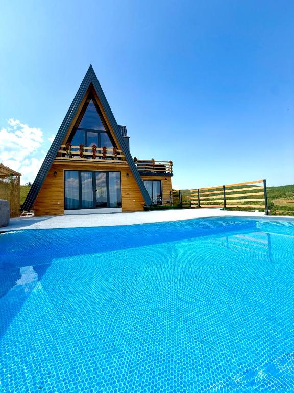 a house with a swimming pool in front of a house at Villa Kovacevic 2 in Bihać