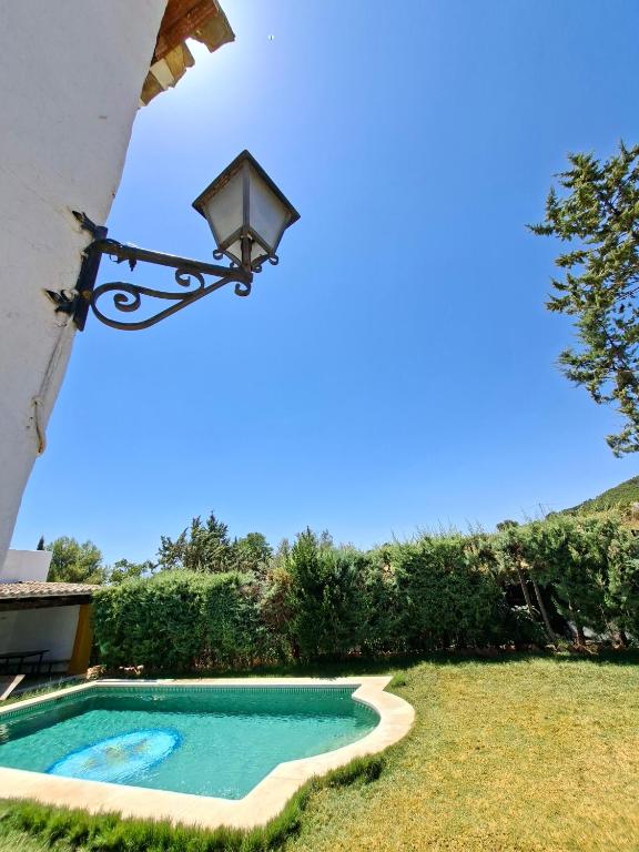 a view of a swimming pool next to a house at Casa Rural La Saucedilla in Archidona