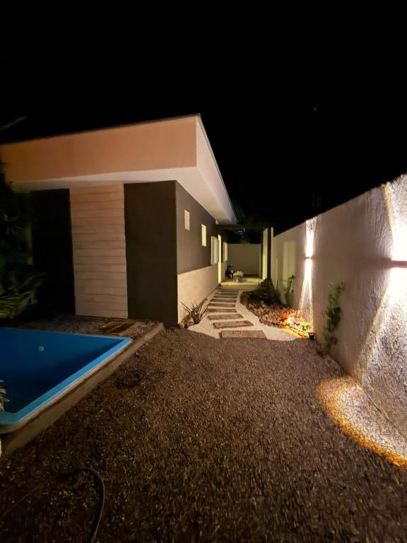 a building with a swimming pool at night at Recanto dos pássaros in Guapimirim