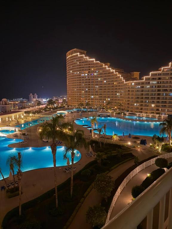 a view of a hotel with a pool at night at 2BR Sea View Chalet Porto sokhna in Ain Sokhna