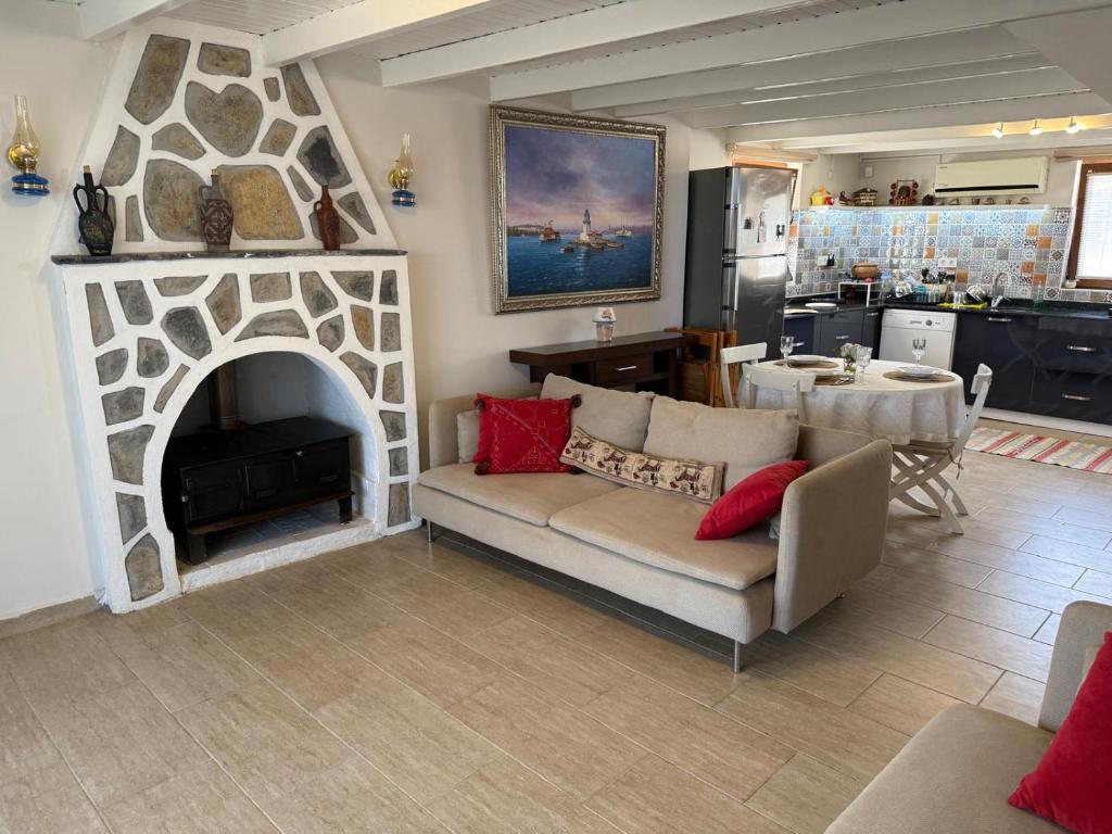 a living room with a couch and a fireplace at Kindya Stone House in Kemikler