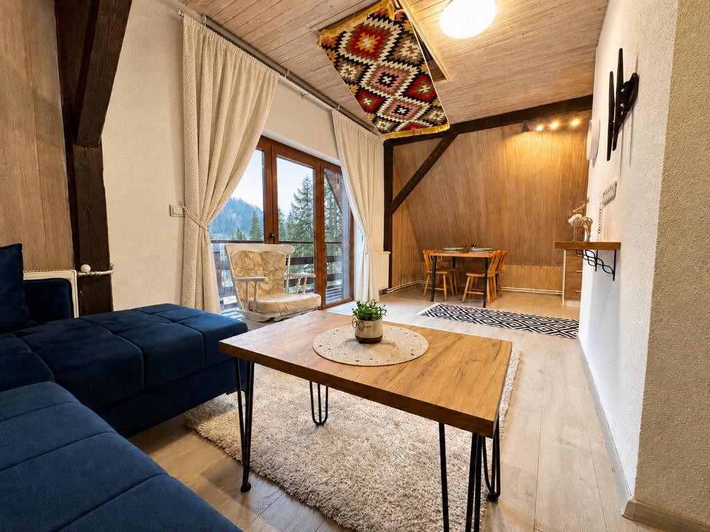a living room with a blue couch and a table at KOTA - Prime Location in Jahorina