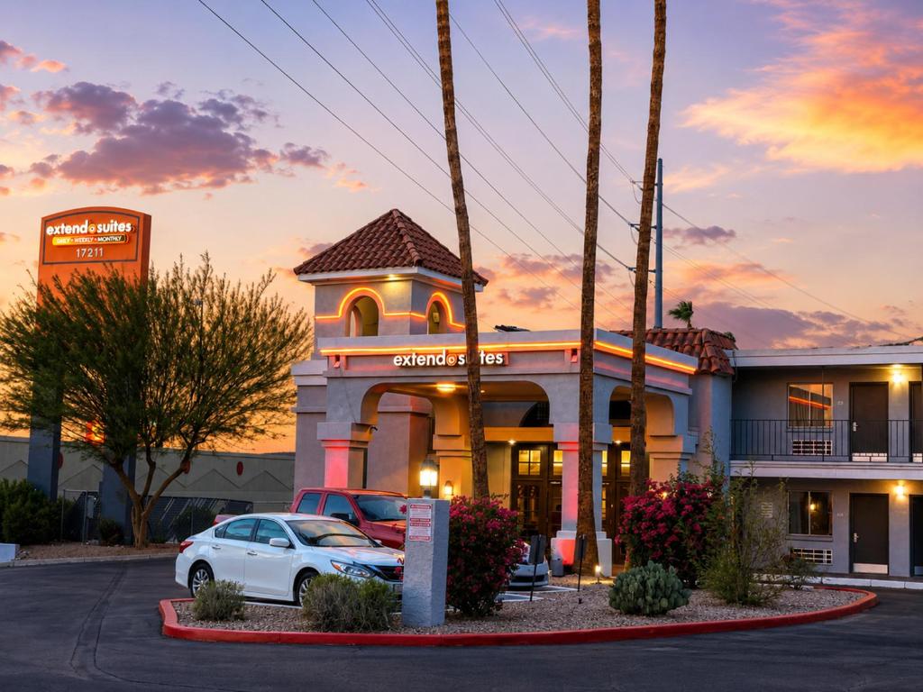 a building with a car parked in front of it at Extend-a-Suites Phoenix in Phoenix