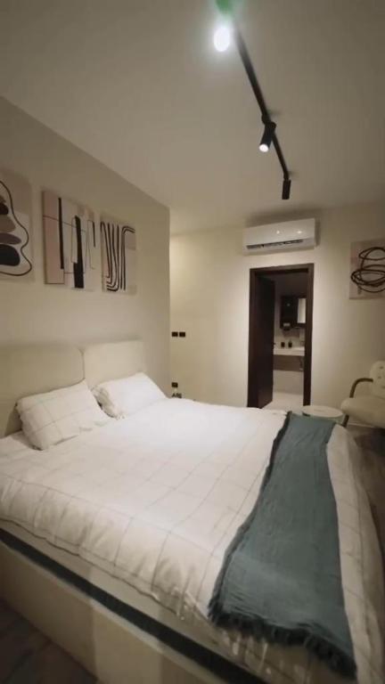 a bedroom with a large white bed in it at مدينتي برافادو in Madinaty