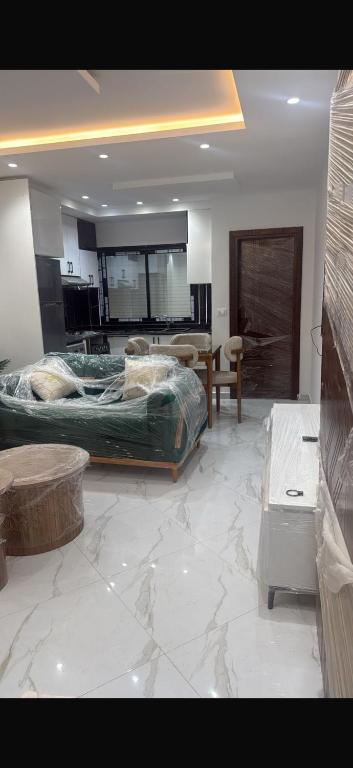 a living room with two beds and a marble floor at Kelibia in Kelibia