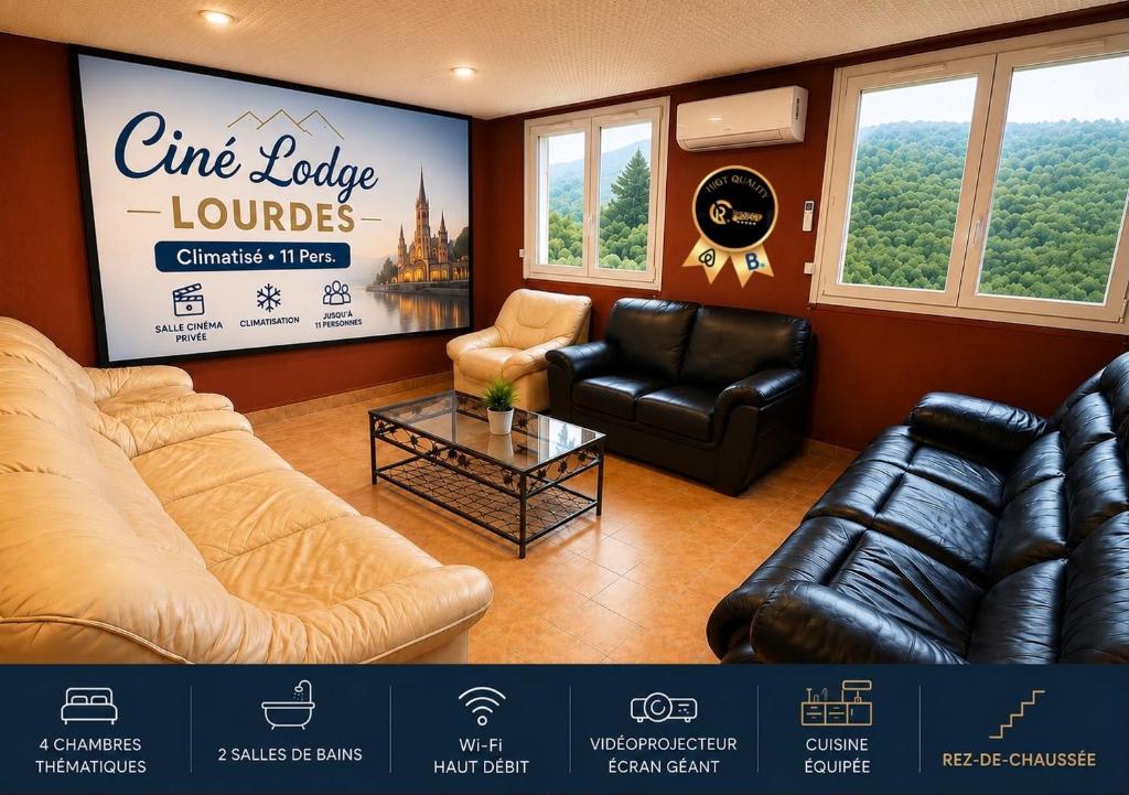 a living room with leather furniture and a large screen at Ciné Lodge Lourdes in Lourdes