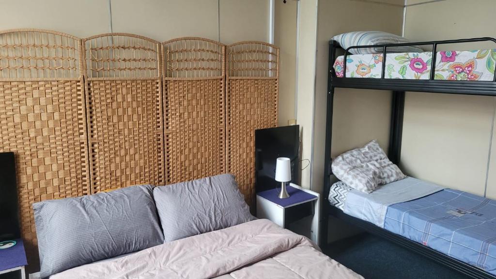 a room with a couch and a bed and bunk beds at Montevideo Hostel in Montevideo