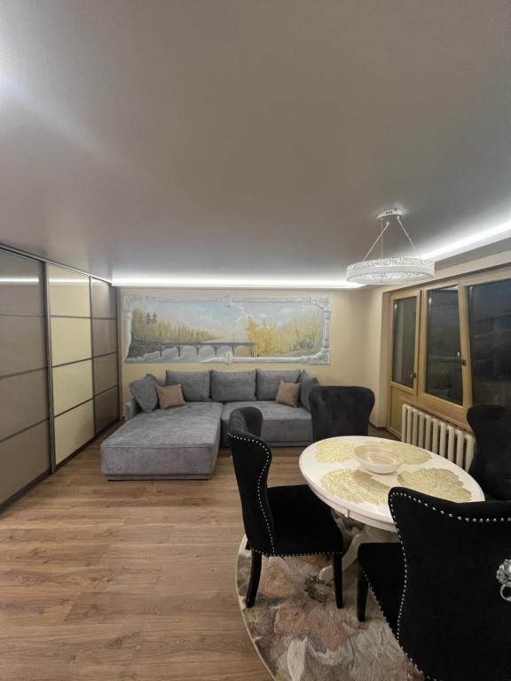 a living room with a couch and a table at Ritos Namai in Druskininkai