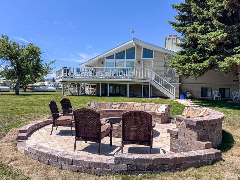 a patio with chairs and a table in front of a house at Bear Lake Ranch with Bear Lake Access in Garden City