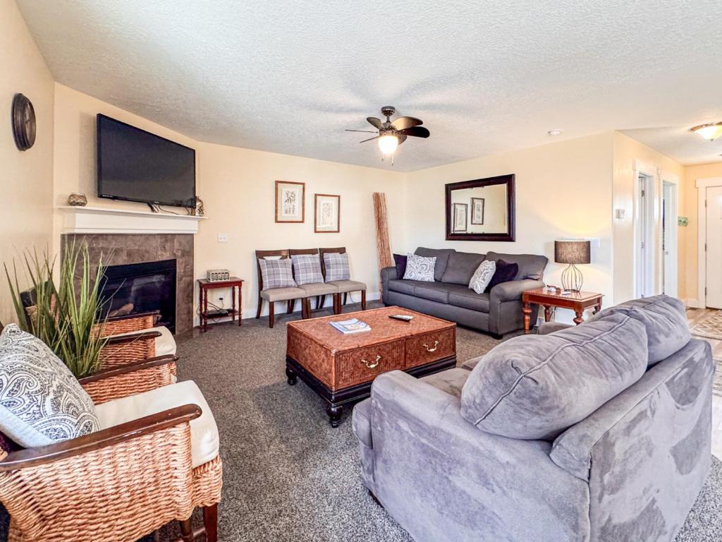 a living room with two couches and a fireplace at Bear Lake Bungalow in Garden City