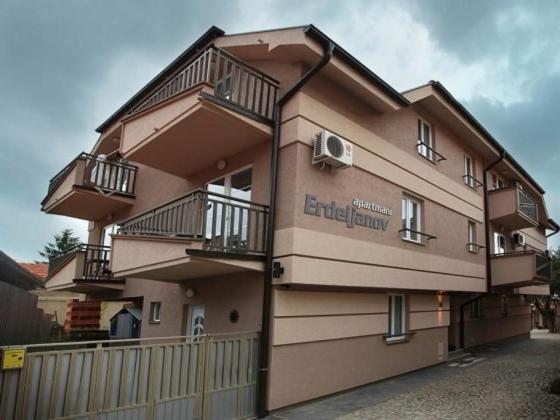 a building with balconies on the side of it at Apartmani Erdeljanov in Soko Banja