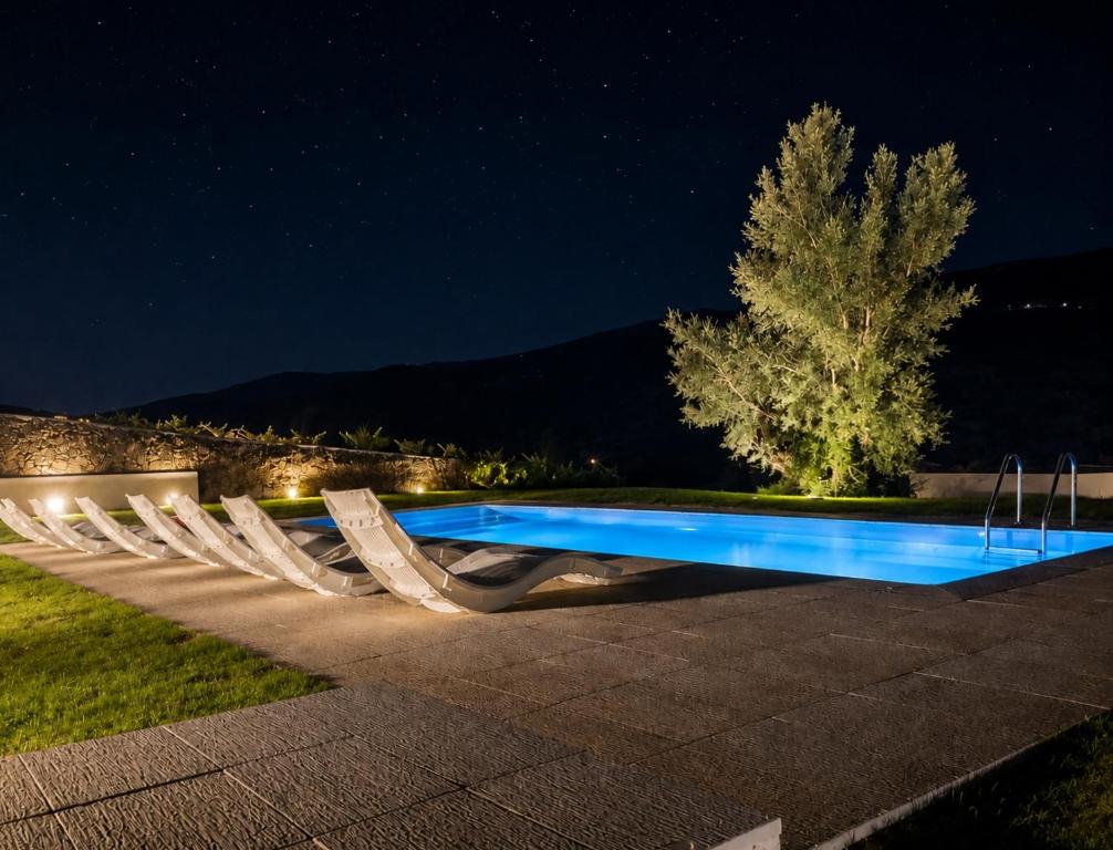 a swimming pool lit up at night at Villa Alzira in Seia