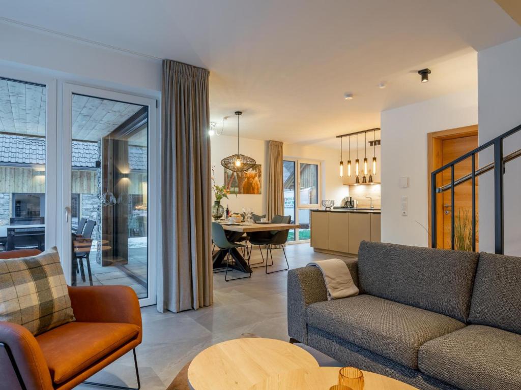 a living room with a couch and a table at Mountain Chalet Chapeau in Sankt Lorenzen ob Murau