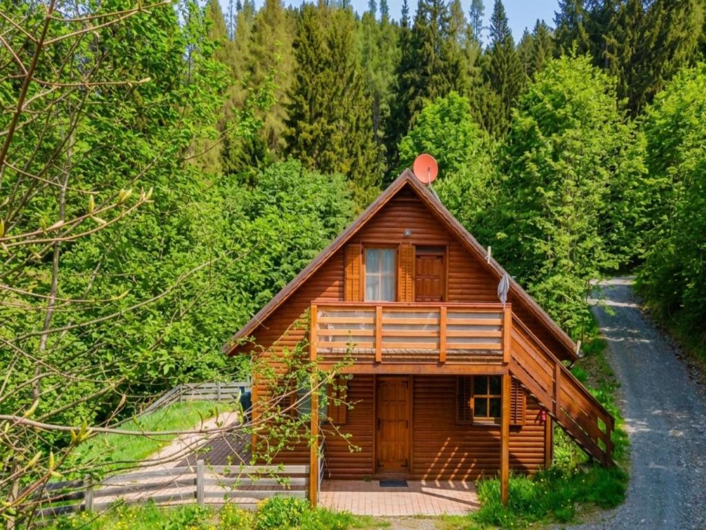 a log cabin in the middle of a forest at Karawankenpanorama S in Liebenfels