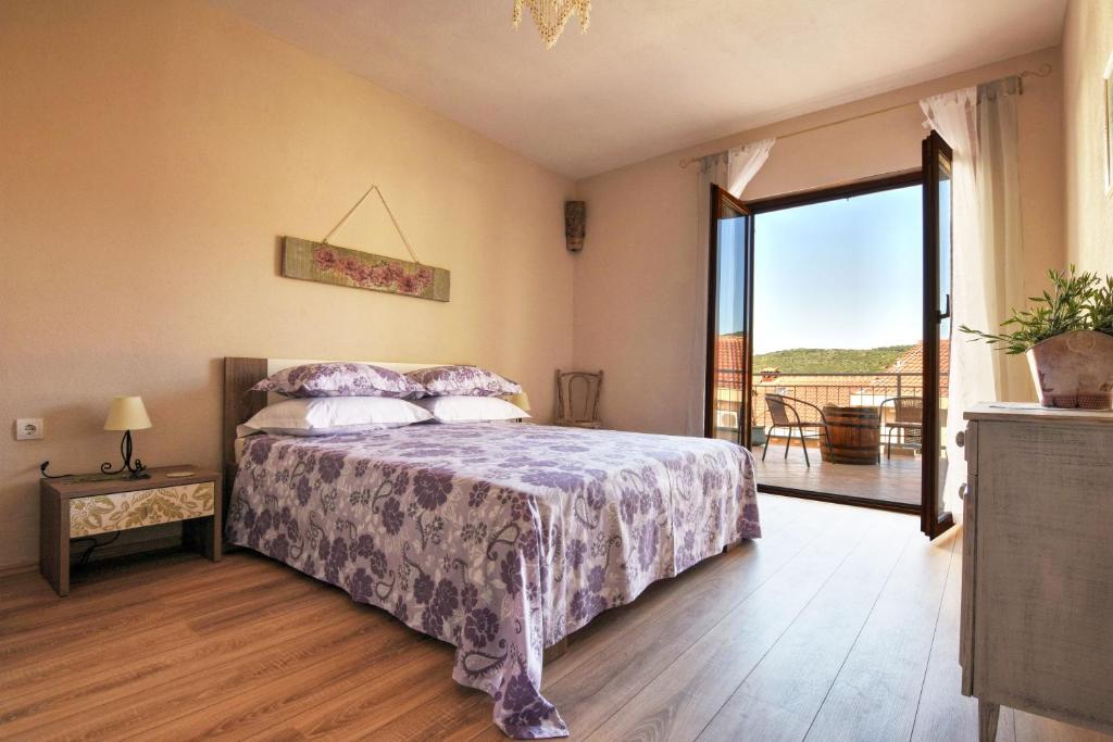 a bedroom with a bed and a large window at Apartment Stella in Vis