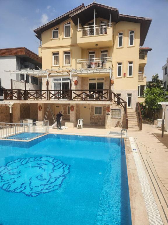 a large swimming pool in front of a building at Safari Suit Hotel , Side in Side