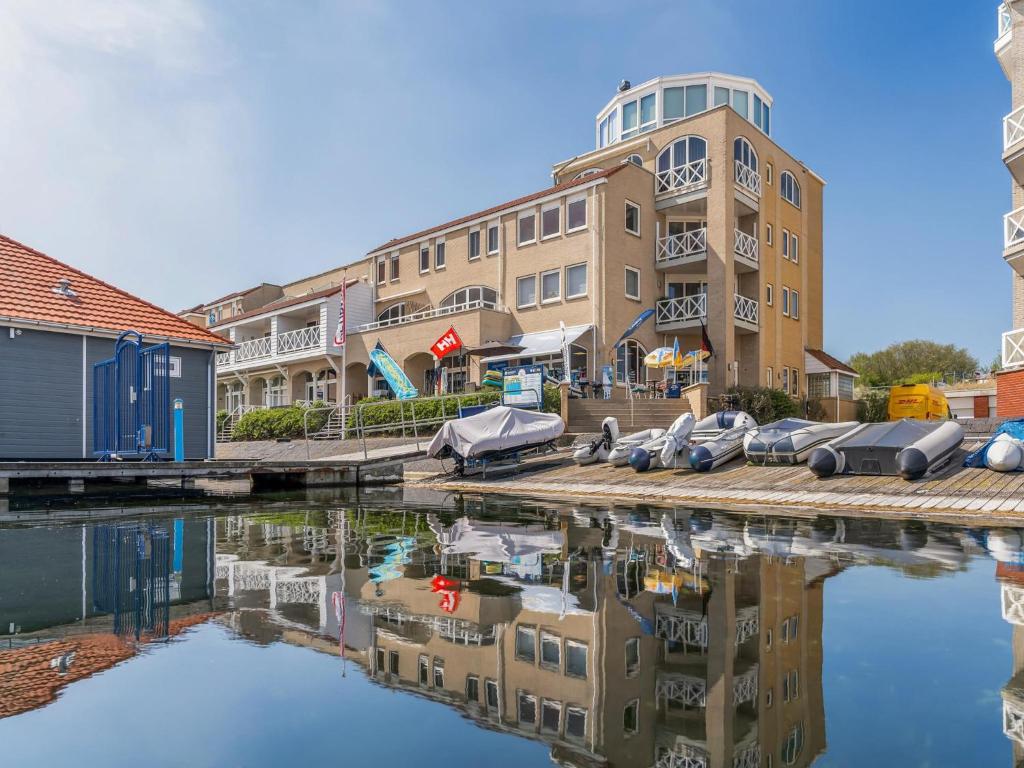 a building with a reflection in a body of water at De Brouwersdam in Ouddorp