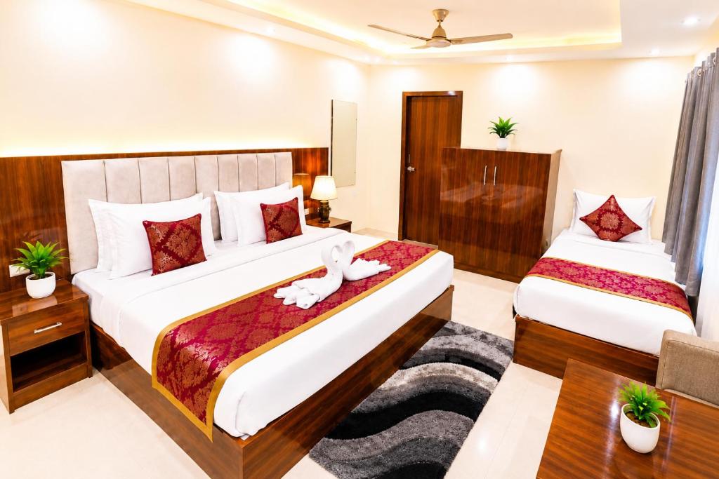 a bedroom with two beds in a room at Hotel Boston Rooms by SOT - Affordable Stay near Taj #Parking #Ac #2 min drive to Taj in Agra